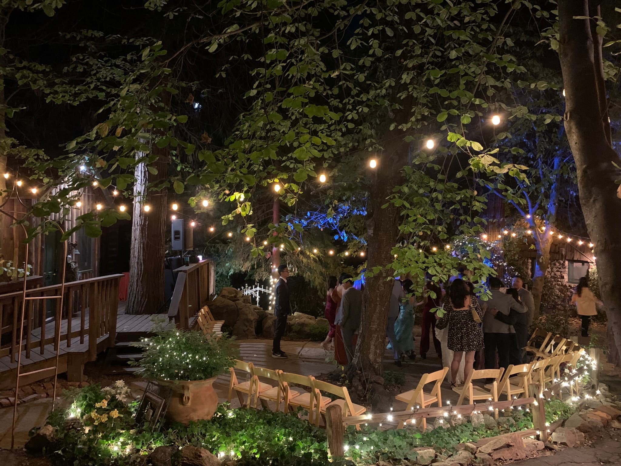 An evening wedding reception under string lights at Willow Woods Park