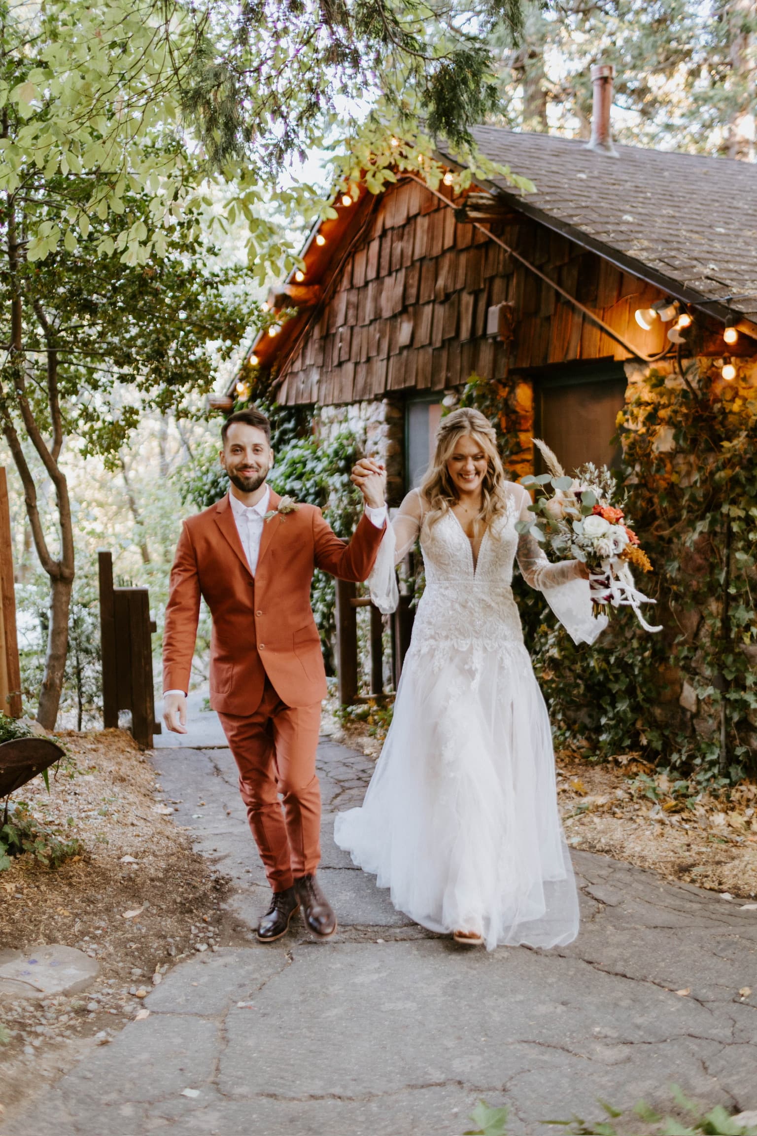 A couple walking back down the path together after their ceremony at Willow Woods Park