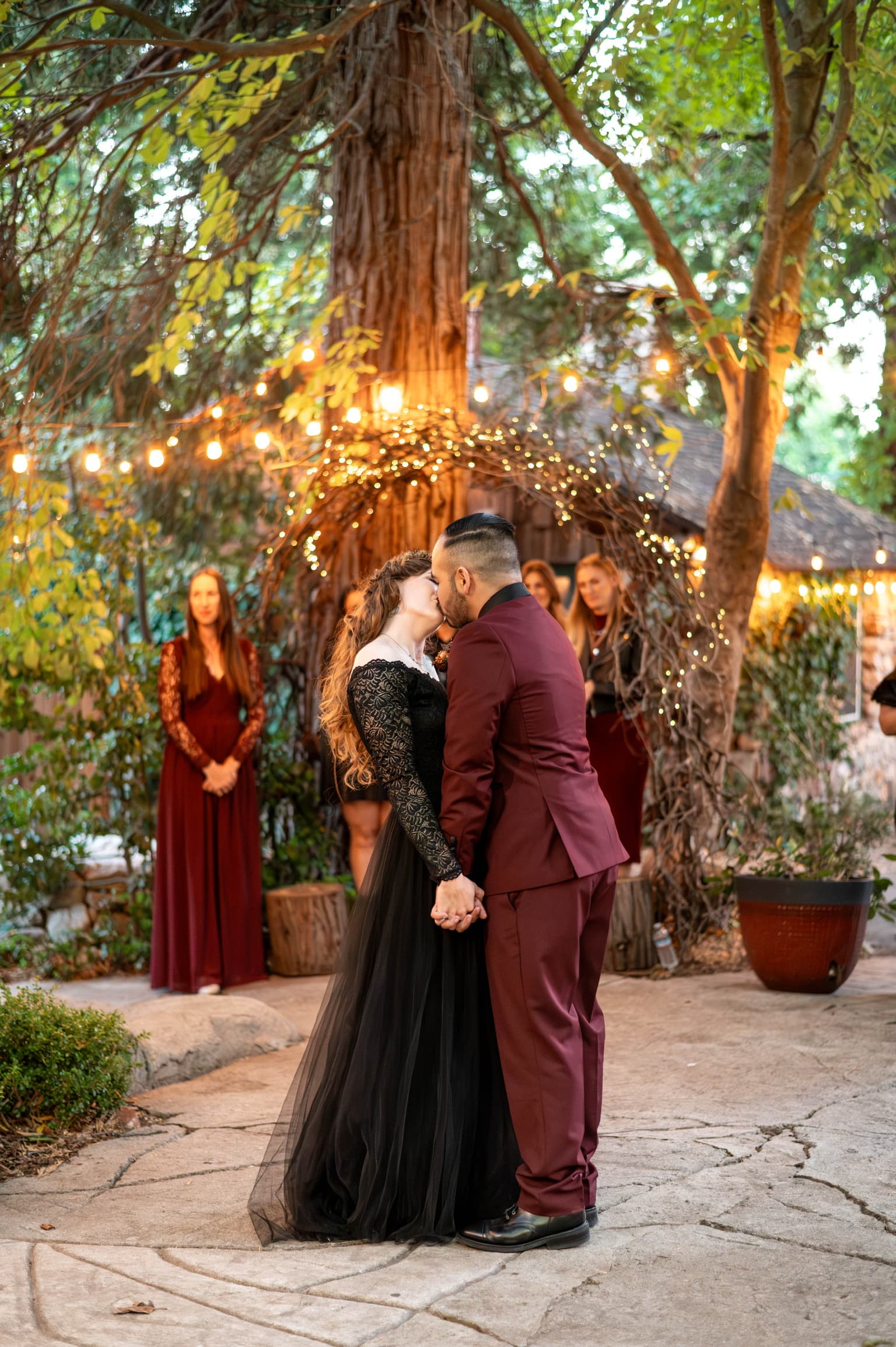 A ceremony under string lights at Willow Woods Park as the light goes