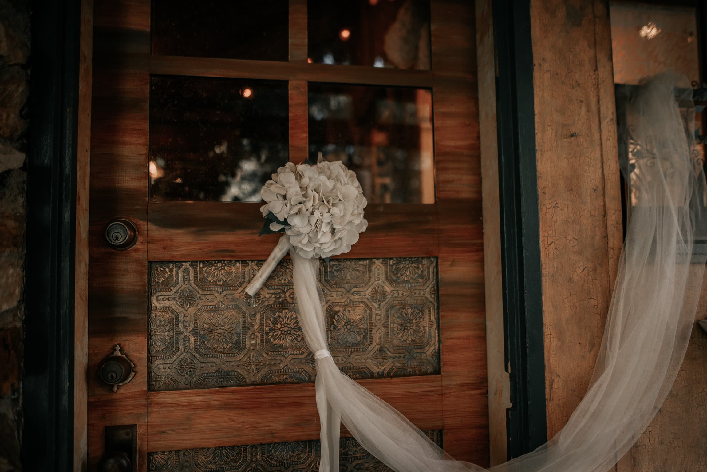 A bouquet and veil hung at the door of one of the 1920s cabins at Willow Woods Park