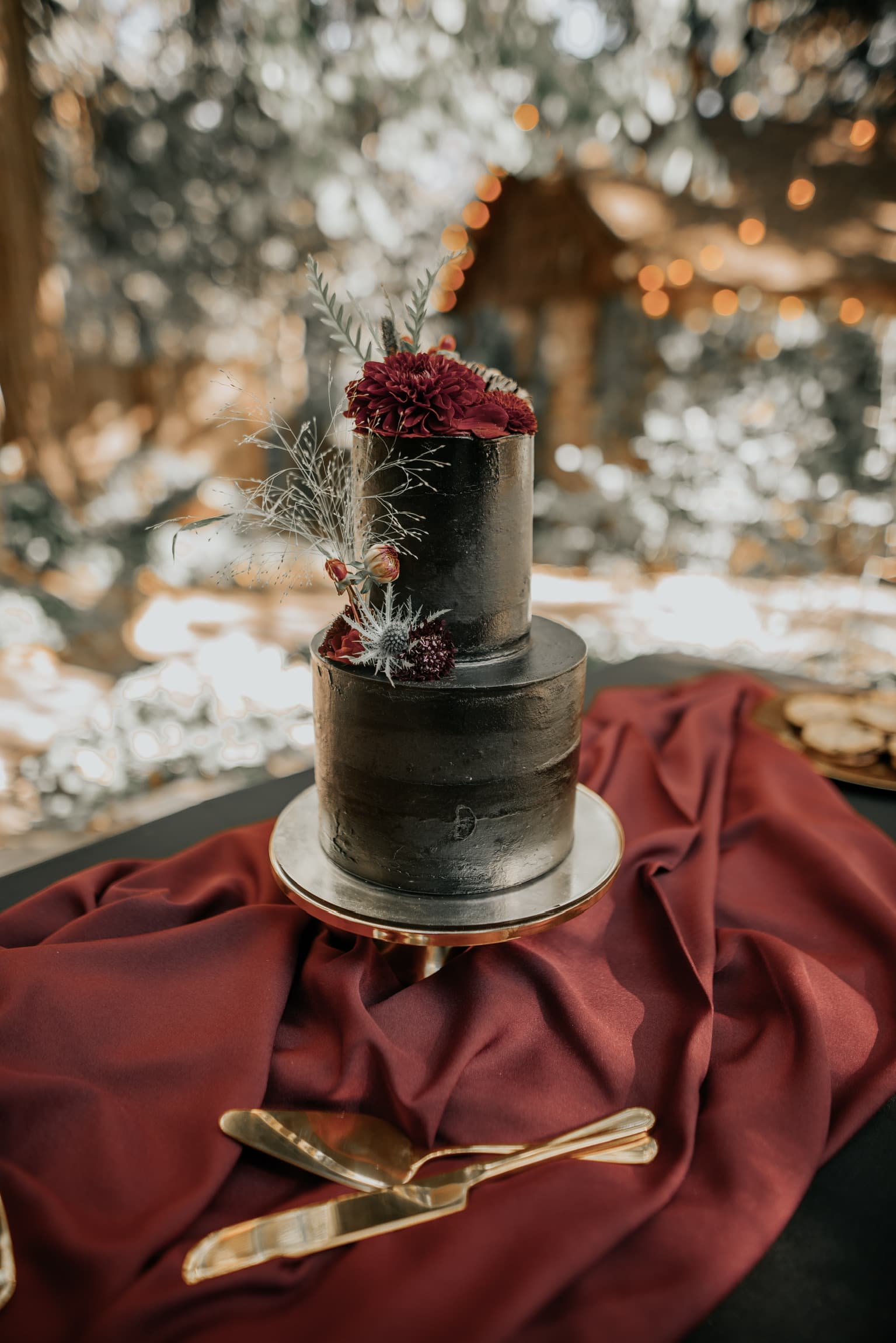 A wedding cake set out on a draped table at Willow Woods Park